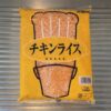 キッチンのシンク上に置かれた、業務スーパーの冷凍チキンライス1kgパッケージ。全体がきれいに写っている。