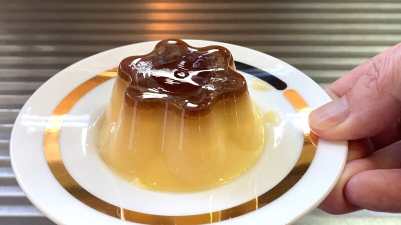 皿に盛られた業務スーパー「練乳仕立てのマイルドプリン」、カラメルソースが光っている様子