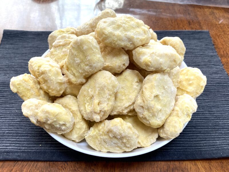 業務スーパーの「チキンナゲット（タイ産）」を冷凍のまま皿に盛りつけた様子。1kg分を山盛りにしたボリューム感が伝わる。
