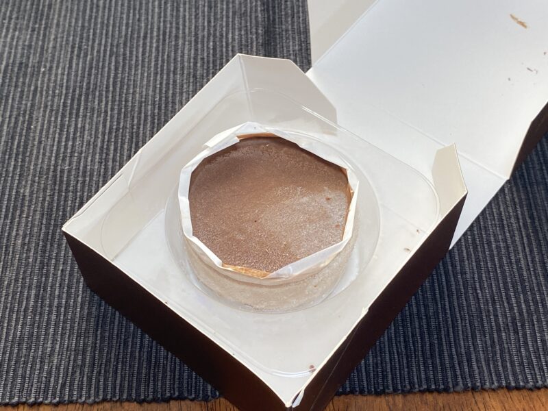 業務スーパー「ガトーショコラの誘惑」を開封した様子。箱の中に冷凍状態のガトーショコラがトレイごと入っている画像