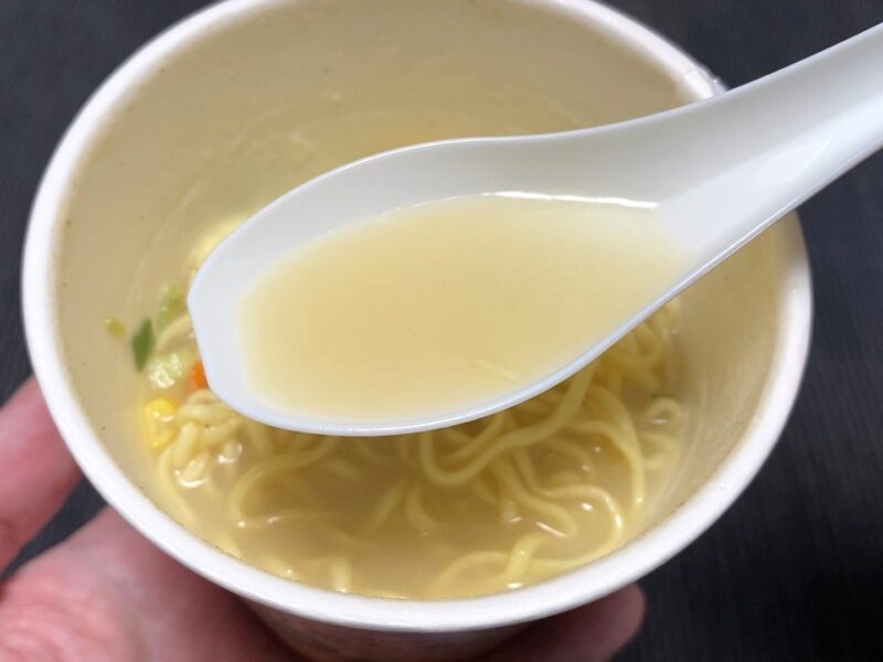 レンゲですくった野菜ちゃんぽんのスープ。油感のない淡いクリーム色のあっさりちゃんぽんスープ