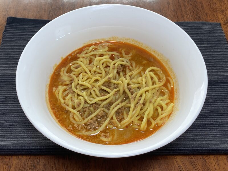 業務スーパー・汁なし担担麺の素をスープ仕立てにした担々麺の完成品・赤いピリ辛スープと麺